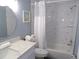 Bathroom featuring marble-style shower and countertops, a toilet, and a sink at 1801 Gulf N Dr # 207, Bradenton Beach, FL 34217