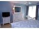 Bedroom view features a white dresser, mirror, side tables, and bed with decorative bedding at 1801 Gulf N Dr # 207, Bradenton Beach, FL 34217