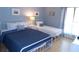 Bedroom features two white metal-frame beds with blue and white bedding, plus a side table at 1801 Gulf N Dr # 207, Bradenton Beach, FL 34217