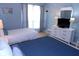 Bright bedroom showcasing two beds, dresser, and natural light from the window at 1801 Gulf N Dr # 207, Bradenton Beach, FL 34217