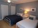 Bedroom features two twin beds, carpet-free flooring, and two white closets at 1801 Gulf N Dr # 207, Bradenton Beach, FL 34217