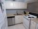 Well-lit kitchen with stainless steel appliances, white cabinets, and ample counter space at 1801 Gulf N Dr # 207, Bradenton Beach, FL 34217