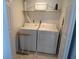 Bright laundry room features a white washer and dryer, plus built-in shelf for extra storage at 1801 Gulf N Dr # 207, Bradenton Beach, FL 34217