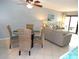 Living area featuring comfortable seating and a view of the balcony at 1801 Gulf N Dr # 207, Bradenton Beach, FL 34217