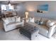 Cozy living room featuring comfortable seating, an ottoman, and a beach-themed painting at 1801 Gulf N Dr # 207, Bradenton Beach, FL 34217