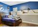A charming bedroom with blue accents, decorative Tampa Bay Lightning hockey decor and natural light at 19351 Ranchview Ct, Land O Lakes, FL 34638