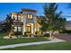 Stunning two-story home with a landscaped yard, illuminated by spotlights at twilight at 19351 Ranchview Ct, Land O Lakes, FL 34638