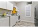 A functional laundry room with modern appliances, cabinets, counterspace and natural light at 19351 Ranchview Ct, Land O Lakes, FL 34638