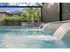 Relaxing swimming pool view featuring decorative waterfalls and palm trees for a resort-style experience at 19351 Ranchview Ct, Land O Lakes, FL 34638