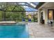 Tranquil poolside scene showcasing the in-ground pool and outdoor furniture on the paved patio at 19351 Ranchview Ct, Land O Lakes, FL 34638