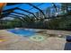 An overhead view of a screened in pool, jacuzzi, and a hot tub and fire pit at 19351 Ranchview Ct, Land O Lakes, FL 34638