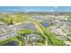 Beautiful aerial view featuring ponds, walking paths, a community pool, and modern residential homes at 2108 Citrus Breeze Dr, Bradenton, FL 34208