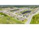 Aerial view showcasing a community with modern homes, well-manicured lawns, and scenic ponds at 2108 Citrus Breeze Dr, Bradenton, FL 34208