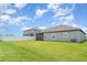 Lush backyard with green lawn, screened lanai, and fenced perimeter, creating a private outdoor retreat at 2108 Citrus Breeze Dr, Bradenton, FL 34208