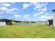 Expansive backyard with a picturesque water view, complemented by a lush green lawn and screened enclosure at 2108 Citrus Breeze Dr, Bradenton, FL 34208