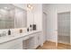 Modern bathroom featuring double sinks, quartz countertop, and a walk-in shower and a walk-in closet at 2108 Citrus Breeze Dr, Bradenton, FL 34208
