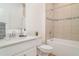 Bright bathroom featuring a single sink vanity with quartz countertop and tile surround shower and tub combo at 2108 Citrus Breeze Dr, Bradenton, FL 34208