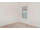 Cozy bedroom with neutral carpet, and a bright window overlooking the exterior of the property at 2108 Citrus Breeze Dr, Bradenton, FL 34208