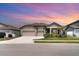 Charming single-Gathering home with a three-car garage, stone accents, and well-manicured landscaping at 2108 Citrus Breeze Dr, Bradenton, FL 34208