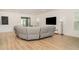 Spacious living room featuring a large sectional sofa, a media console, and large windows for natural light at 2108 Citrus Breeze Dr, Bradenton, FL 34208