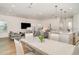 Bright and open living space with modern furnishings, an island with bar seating, and hardwood floors at 2108 Citrus Breeze Dr, Bradenton, FL 34208