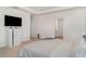 Bright main bedroom with a walk in to the bathroom and large dresser in a neutral color scheme at 2108 Citrus Breeze Dr, Bradenton, FL 34208