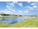 Scenic water view featuring a tranquil pond surrounded by well-maintained lawns and beautiful landscaping at 2108 Citrus Breeze Dr, Bradenton, FL 34208