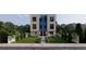 Modern two-story townhome with a blue central accent, black windows, and landscaped front yard at 2146 5Th N Ave, St Petersburg, FL 33713