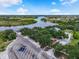 Aerial view of a community boat ramp, river, and residential neighborhood on a sunny day at 2347 123Rd E Pl, Parrish, FL 34219