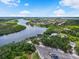 Aerial view of a wide river, residential community, and lush green space under a partly cloudy sky at 2347 123Rd E Pl, Parrish, FL 34219