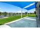 Beautiful backyard with lush grass, a tranquil pond, and a shaded patio area at 2347 123Rd E Pl, Parrish, FL 34219