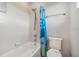 Clean bathroom with white tile, updated fixtures, and a colorful shower curtain at 2347 123Rd E Pl, Parrish, FL 34219