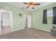 Bedroom with green walls, carpet, ceiling fan, and closet at 2347 123Rd E Pl, Parrish, FL 34219