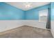 Bedroom with two-tone blue and white walls, carpet, and a window at 2347 123Rd E Pl, Parrish, FL 34219