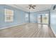 Spacious bedroom with light blue walls, wood-look flooring, and a sliding glass door to the backyard at 2347 123Rd E Pl, Parrish, FL 34219
