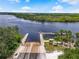 Wide shot of a concrete boat ramp with wooden pier, near benches and palm trees at 2347 123Rd E Pl, Parrish, FL 34219