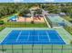 Aerial shot showcasing community amenities: tennis, basketball courts, and playground at 2347 123Rd E Pl, Parrish, FL 34219