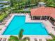 A view showcasing a community pool featuring clear blue water, poolside seating, and lush landscaping at 2347 123Rd E Pl, Parrish, FL 34219