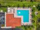 An aerial view highlights a large community pool with ample seating and well-maintained surroundings at 2347 123Rd E Pl, Parrish, FL 34219