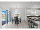 Eat-in kitchen and dining area with chandelier, island seating, and access to the lanai at 2347 123Rd E Pl, Parrish, FL 34219