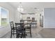 Dining area featuring a chandelier and modern black table set, adjacent to the kitchen at 2347 123Rd E Pl, Parrish, FL 34219