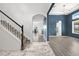 Welcoming foyer features wood-look floors, staircase, archway, and views of the adjacent living and dining areas at 2347 123Rd E Pl, Parrish, FL 34219