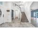 Spacious foyer with staircase offers an inviting entrance and views of the home's layout at 2347 123Rd E Pl, Parrish, FL 34219