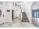 Spacious foyer with a staircase, tile flooring, high ceilings, and access to the living areas at 2347 123Rd E Pl, Parrish, FL 34219