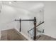 Second floor hallway with hardwood style floors and a view down the carpeted stairs at 2347 123Rd E Pl, Parrish, FL 34219