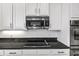 Close-up of the kitchen featuring stainless steel appliances, granite countertops, and white cabinetry at 2347 123Rd E Pl, Parrish, FL 34219