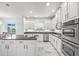 Modern kitchen featuring white cabinets, stainless steel appliances, and granite countertops at 2347 123Rd E Pl, Parrish, FL 34219