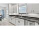 Kitchen sink and counter area with stainless steel appliances, granite counters, and white cabinets at 2347 123Rd E Pl, Parrish, FL 34219