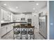 Open kitchen with island, white cabinets, granite countertops, and stainless steel appliances at 2347 123Rd E Pl, Parrish, FL 34219