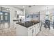 Kitchen island with granite countertop and sink, with stainless steel refrigerator nearby at 2347 123Rd E Pl, Parrish, FL 34219